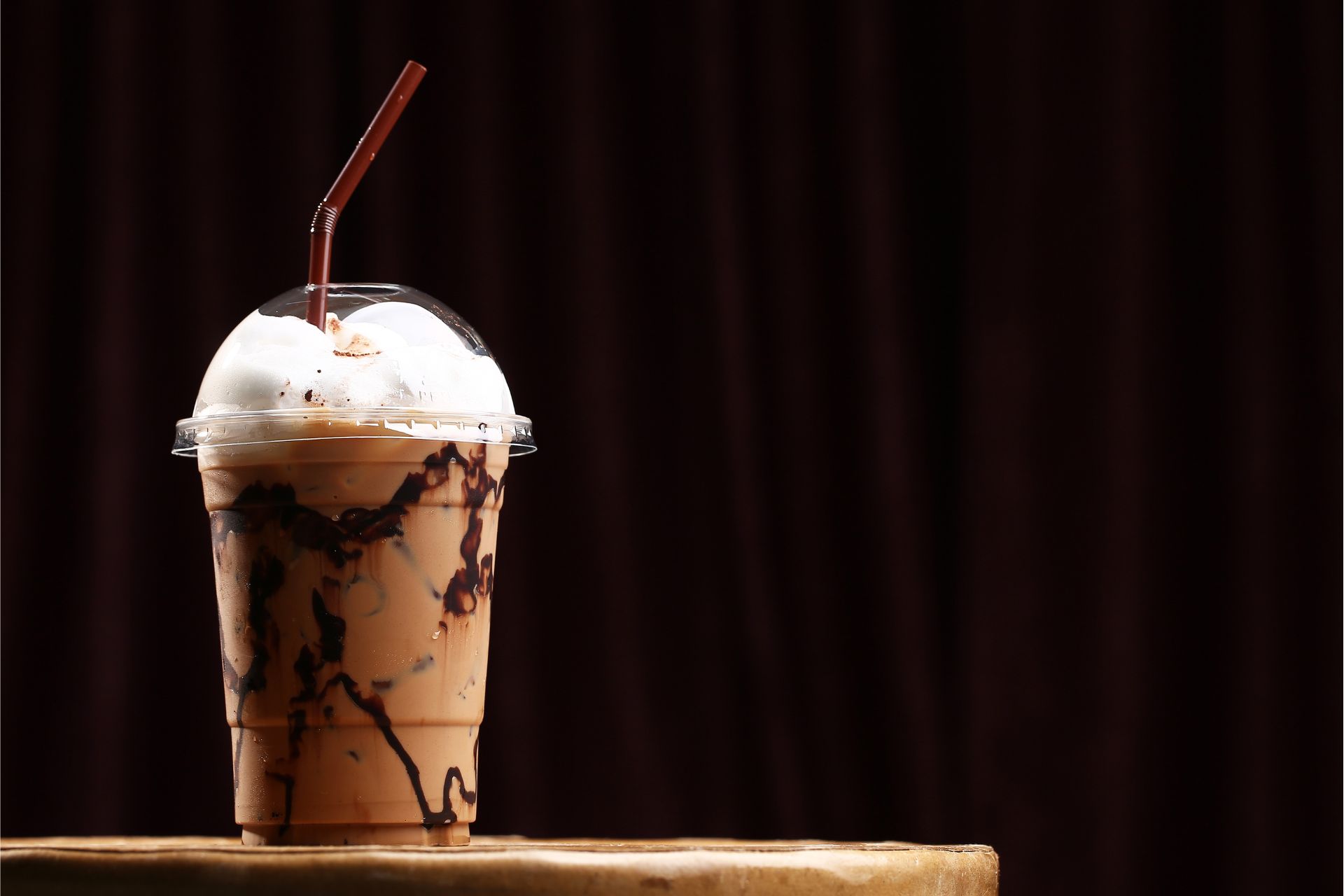 Rows of flavored coffee syrups with pump dispensers lined up on a café counter